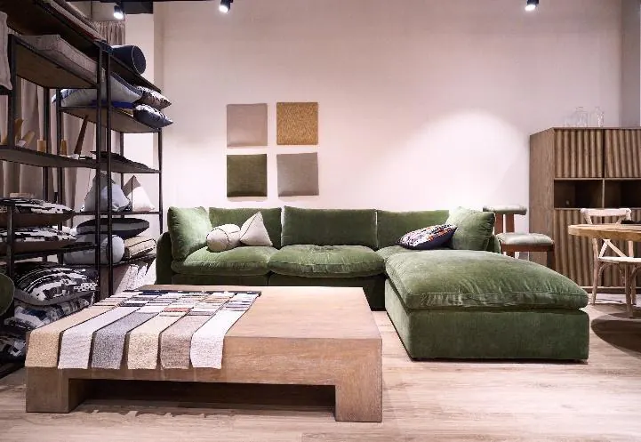 Green velvet sectional and fabric swatches in the Vietnam showroom